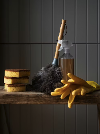 Screenshot 0008-05-24 at 13.27.52 Cleaning supplies on a shelf. 3 Sponges stacked next to a duster, a spray bottle and yellow gloves