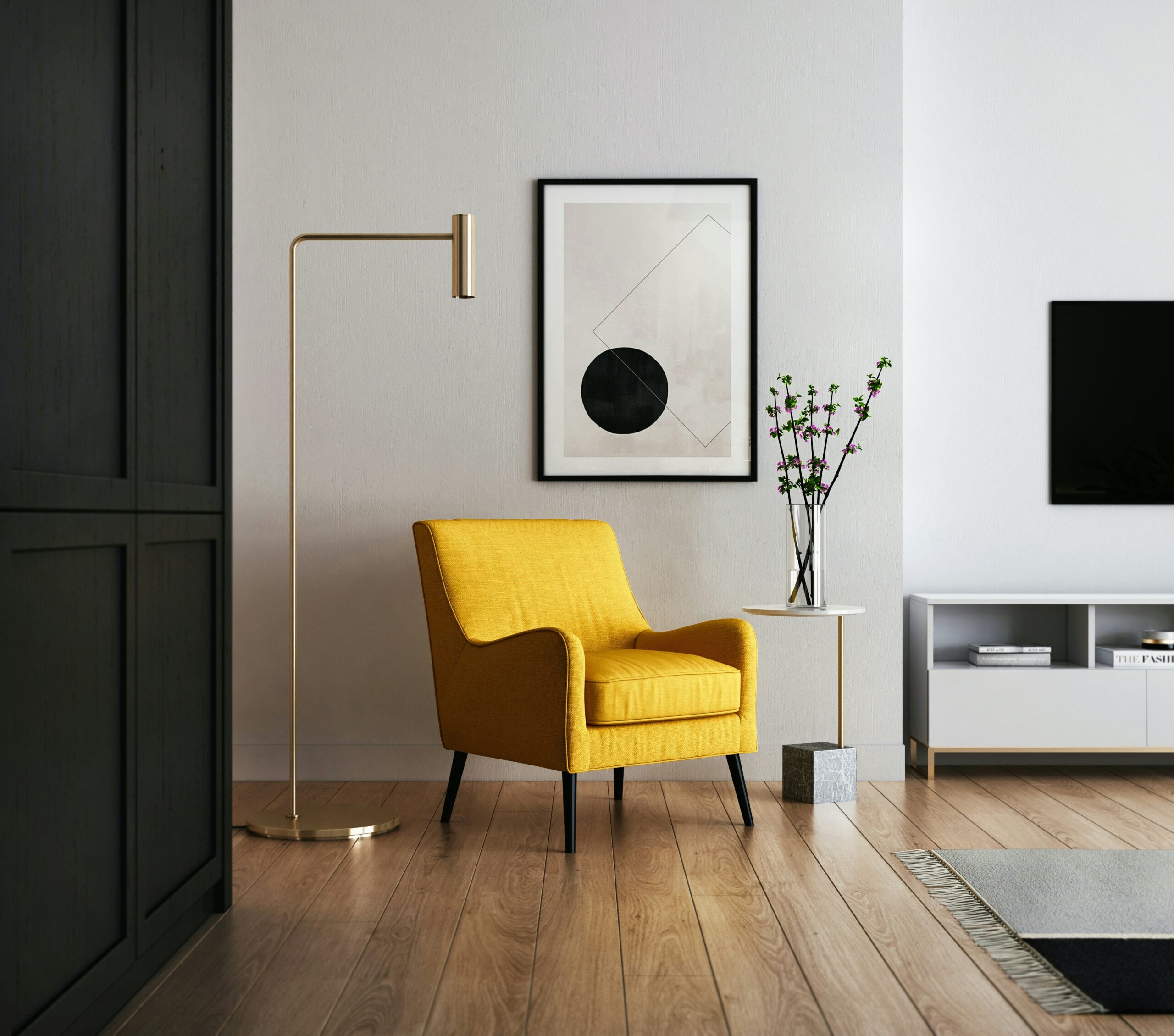 kam-idris-_HqHX3LBN18-unsplash A neat modern living room space with a yellow chair in the center and a lamp stand beside it